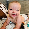 Presley joined the competition — help win amazing prizes! baby, smiling, diaper, blanket, couch, pillow, face, happy, infant, skin, eyes, cheeks, arm, hand, indoor, comfort, cute, lying_down, child, home