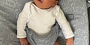 Natalie joined the competition — help win amazing prizes! baby, infant, white_onesie, socks, baby_seat, elephant_pattern, gray, diaper, indoor, carpet, denim, curious, face, legs, hands, newborn, child, seatbelt, soft_lighting, closeup