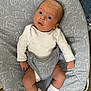 baby, infant, white_onesie, socks, baby_seat, elephant_pattern, gray, diaper, indoor, carpet, denim, curious, face, legs, hands, newborn, child, seatbelt, soft_lighting, closeup