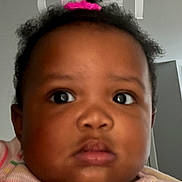 Kaliyah joined the competition — help win amazing prizes! baby, child, face, portrait, closeup, person, hair, hair_tie, pink, striped_shirt, expression, indoor, lock_screen, phone_screen, time_display, date_display, flashlight_icon, camera_icon, black_hair, curly_hair