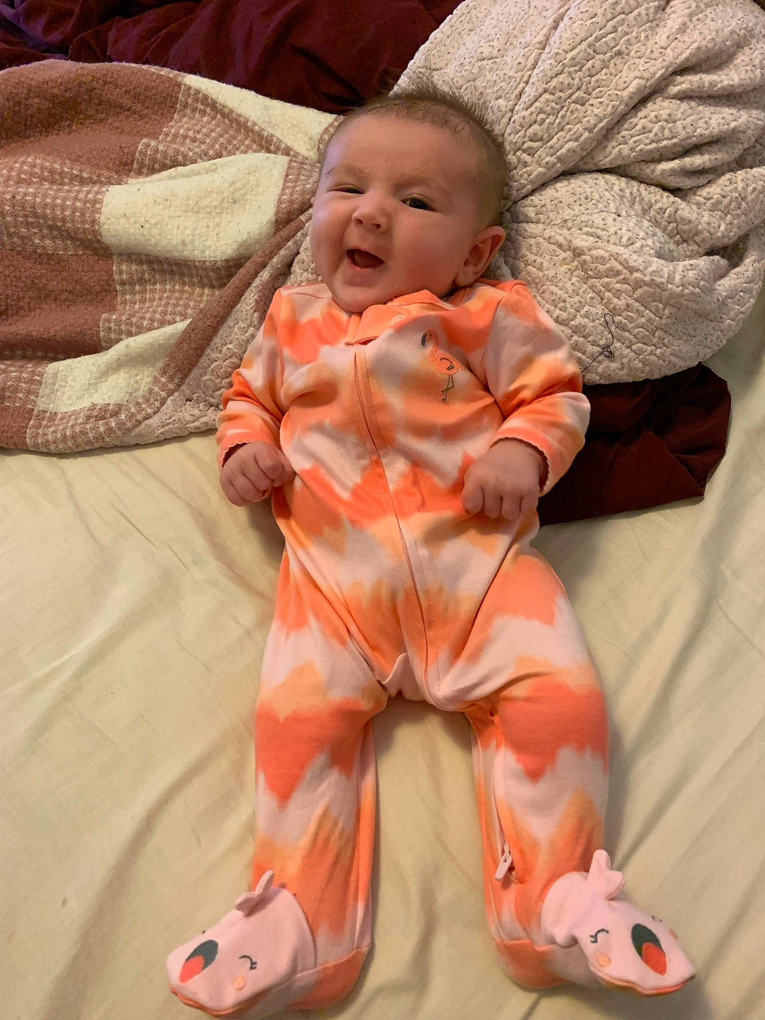 Giana is registered to the contest to win money with this photo: baby, baby_toddler_clothing, carmine, cheek, child, comfort, face, foot, happy, linens, nose, orange, peach, person, sitting, sleeve, smile, textile, thumb, toddler