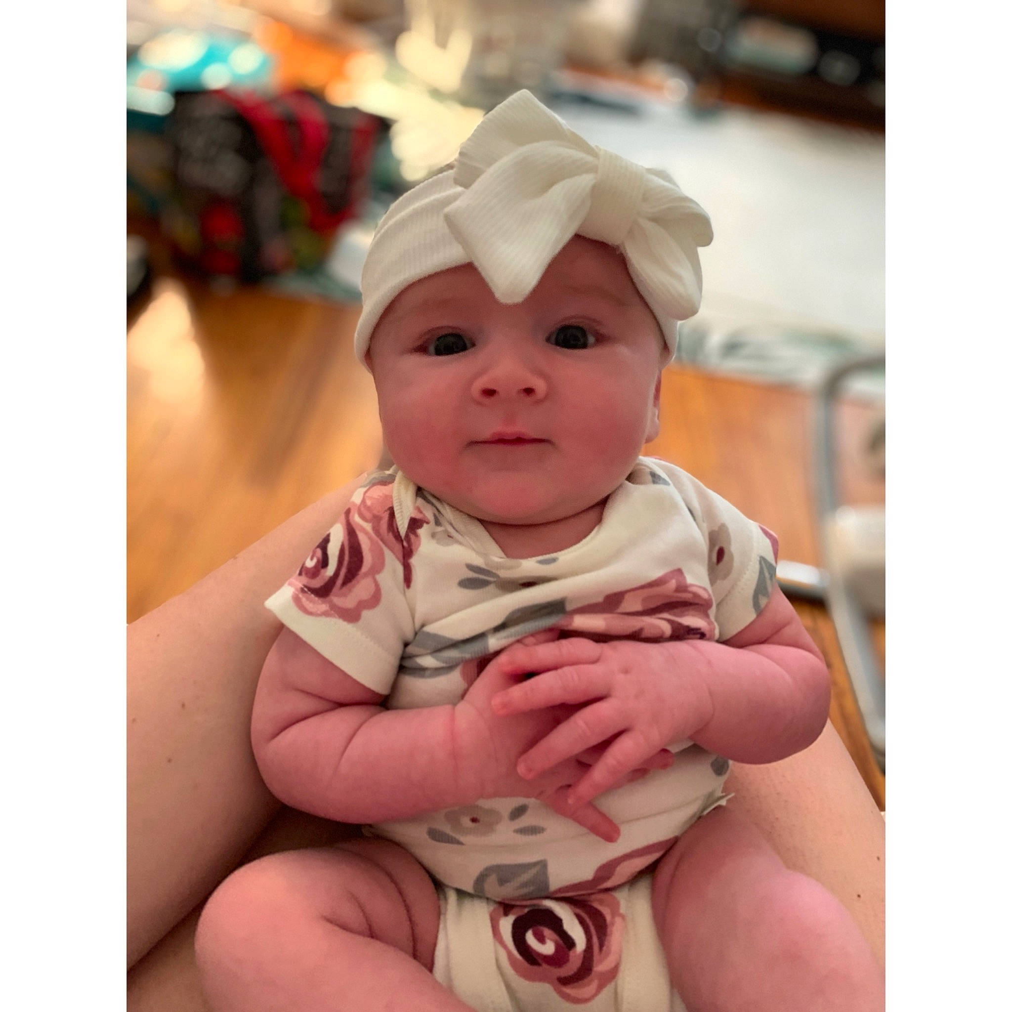 Giana is registered to the contest to win money with this photo: arm, baby, baby_products, baby_toddler_clothing, cheek, child, comfort, face, fun, gesture, happy, headwear, human_body, iris, nail, person, pink, sitting, skin, sleeve