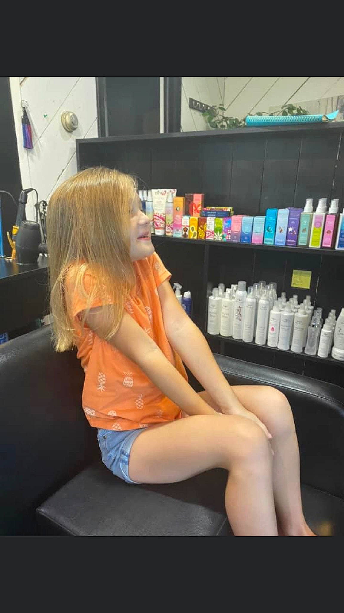 Kenleigh is registered to the contest to win money with this photo: automotive_design, blond, bookcase, brown_hair, chair, electric_blue, fun, human_leg, joint, knee, lap, leg, leisure, long_hair, person, publication, shelf, shelving, shorts, sitting