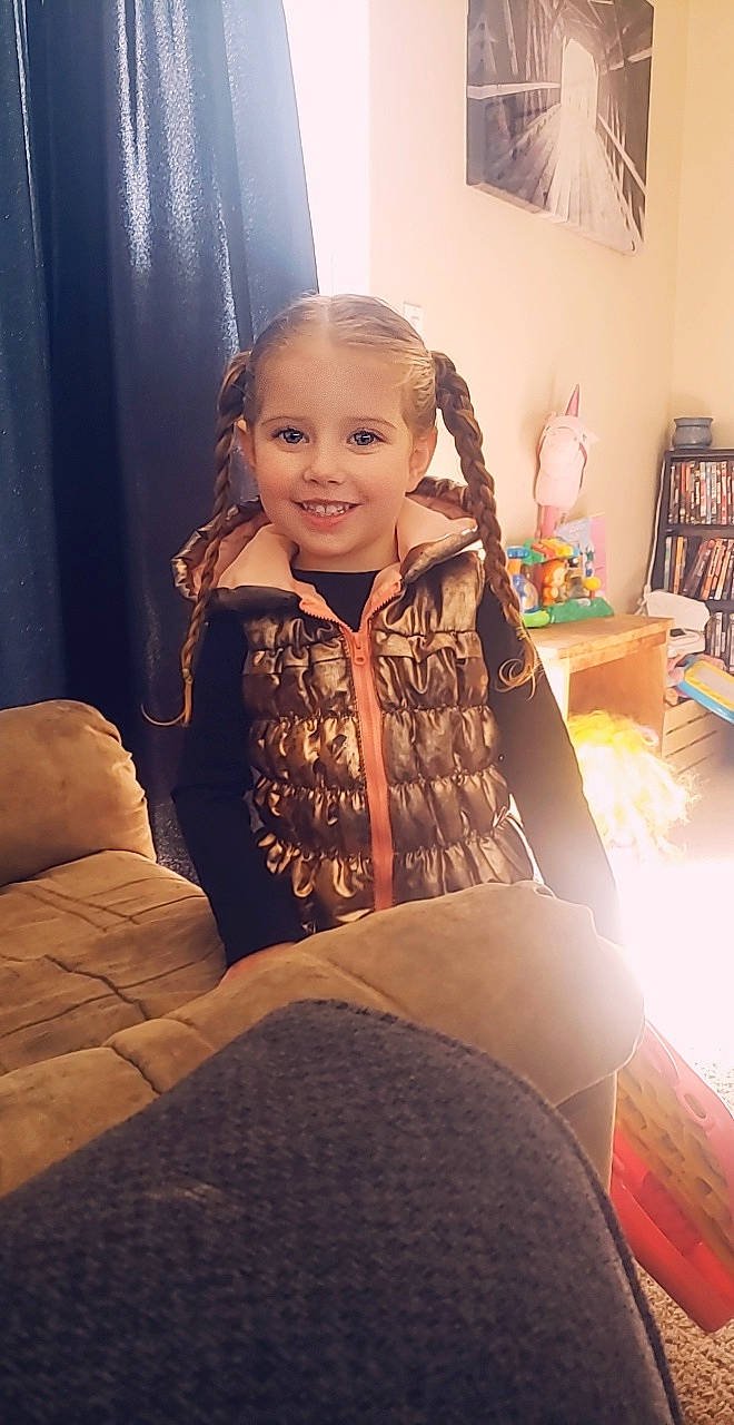 Paityn Jean joined the competition — help win amazing prizes! chair, child, couch, face, furniture, head, joy, long_hair, person, sitting, skin, toddler