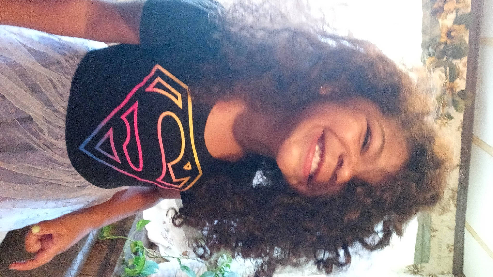 Zendaya is registered to the contest to win money with this photo: bangs, black_hair, brown_hair, cool, eyelash, forehead, fun, grass, happy, jaw, joy, leisure, long_hair, mouth, neck, nose, organism, person, smile, summer