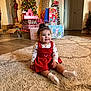child, toddler, baby, christmas_tree, presents, gifts, red_dress, rug, living_room, holiday, smile, socks, wood_floor, ornaments, stockings, wrapped_gifts, indoor, portrait, happy, festive