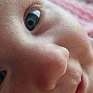 Nora joined the competition — help win amazing prizes! child, closeup, face, eye, skin, nose, mouth, eyelashes, portrait, infant, baby, soft_light, texture, expression, curious, innocence, blurred_background, indoor, warm, intimate