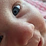child, closeup, face, eye, skin, nose, mouth, eyelashes, portrait, infant, baby, soft_light, texture, expression, curious, innocence, blurred_background, indoor, warm, intimate