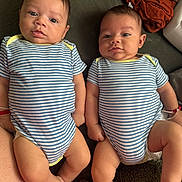 Dilan Y Lian joined the competition — help win amazing prizes! babies, blue_clothing, children, clothing, couch, eyes, fabric, faces, family_photo, indoor, infants, legs, lying_down, matching_outfits, pile_of_clothes, portrait, sitting, striped_onesies, twins, white_clothing