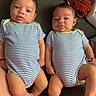babies, blue_clothing, children, clothing, couch, eyes, fabric, faces, family_photo, indoor, infants, legs, lying_down, matching_outfits, pile_of_clothes, portrait, sitting, striped_onesies, twins, white_clothing