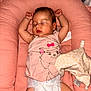 baby, sleeping, diaper, pink, plush_toy, giraffe, infant, cute, cozy, cushion, clothing, toddler, child, face, arms_up, resting, indoors, soft, peaceful, naptime