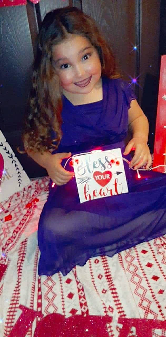 Jaelah is registered to the contest to win money with this photo: brown_hair, carmine, child, electric_blue, event, fun, happy, holiday, human_leg, joy, lap, long_hair, magenta, pattern, person, sitting, sleeve, smile, sock, sweetness