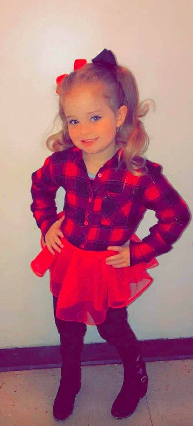 Khloe joined the competition — help win amazing prizes! baby_toddler_clothing, face, fashion_design, hair, head, human_body, joy, knee, lip, magenta, outerwear, pattern, person, pink, plaid, red, sleeve, smile, sock, tartan