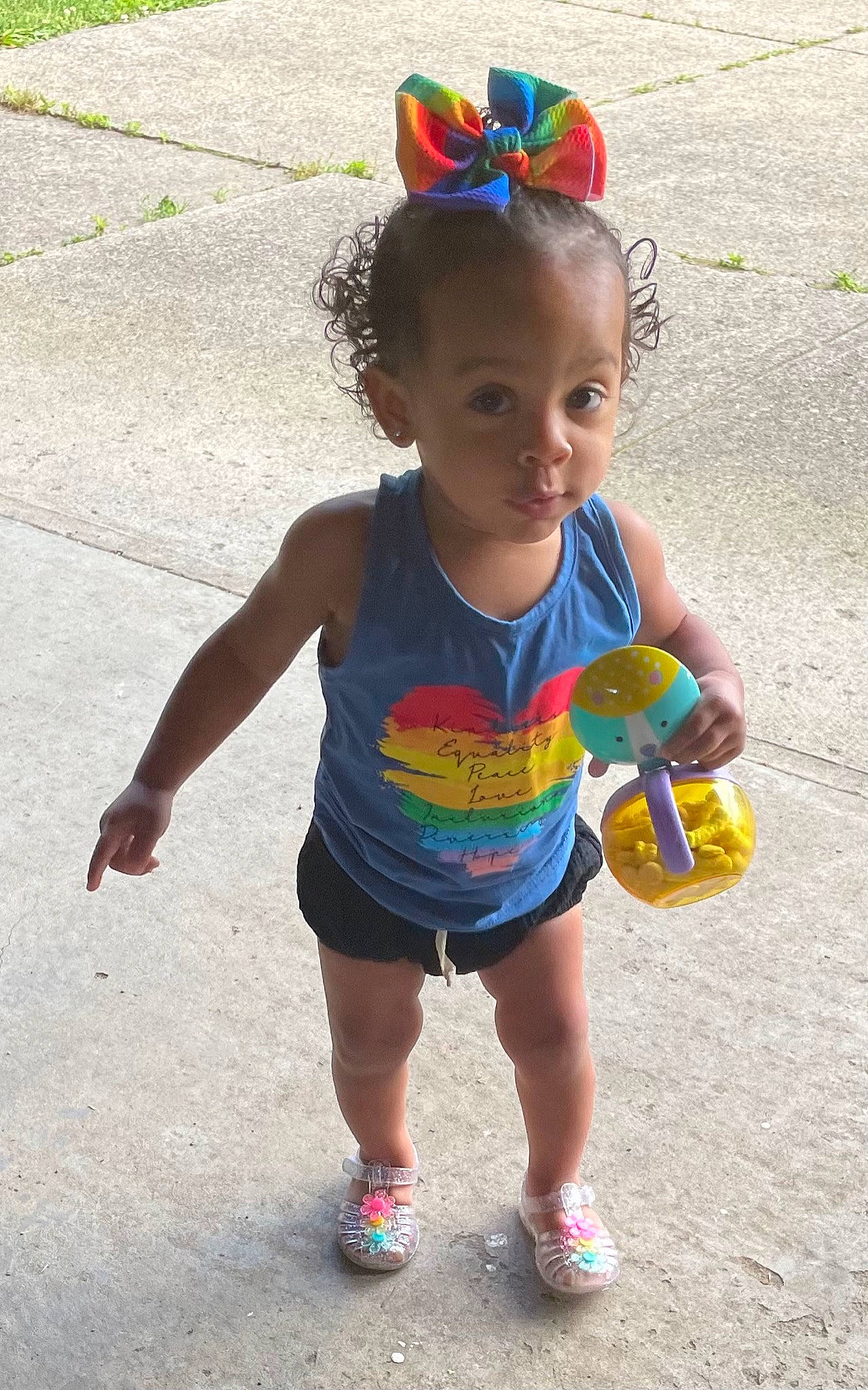 Zoey is registered to the contest to win money with this photo: arm, baby_toddler_clothing, child, clothing, drinkware, eye, face, facial_expression, fun, hair, happy, head, leisure, person, recreation, shorts, smile, thigh, toddler, water