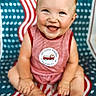 baby, child, smiling, happy, sitting, blanket, red_stripes, blue_stars, clothing, cute, portrait, infant, face, feet, hands, pattern, background, cute_baby, young_child, indoors