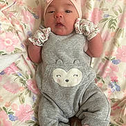 Samara Rose Becerra joined the competition — help win amazing prizes! baby, infant, blanket, floral, pink, grey_overalls, mittens, headband, bow, cute, soft, cozy, sleepwear, child, portrait, lying_down, small_hands, socks, comfortable, indoors