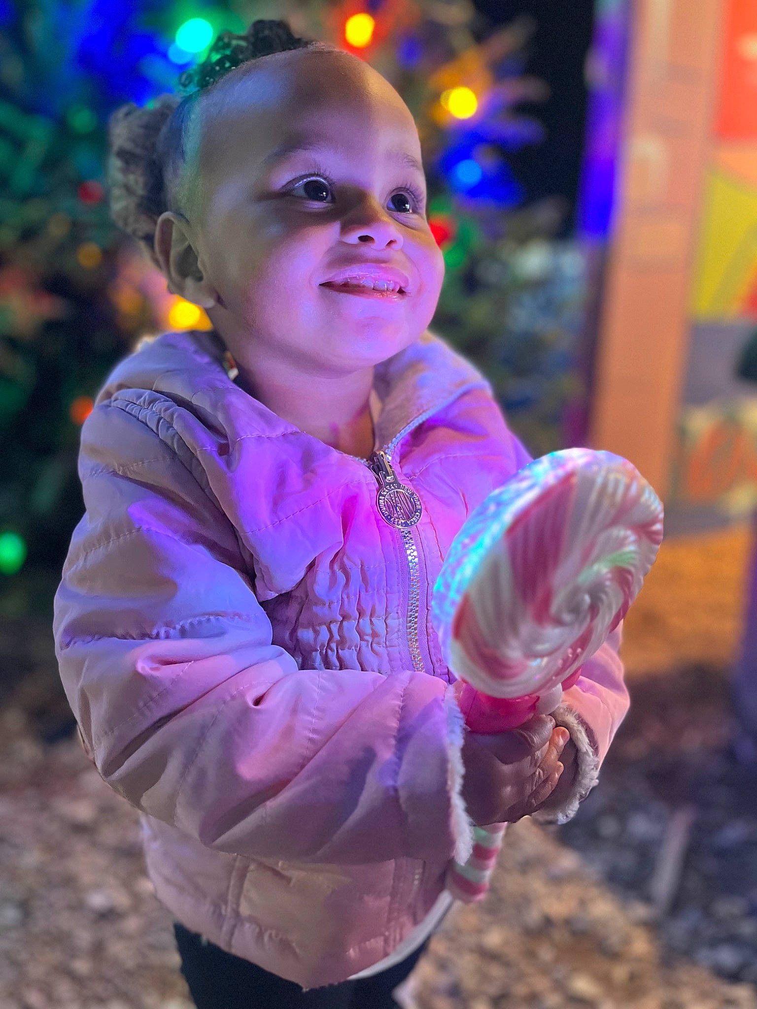 Anylah is registered to the contest to win money with this photo: baby, child, christmas_decoration, christmas_ornament, entertainment, event, eye, fun, grass, happy, head, leisure, magenta, people_in_nature, person, pink, plant, sitting, smile, toddler