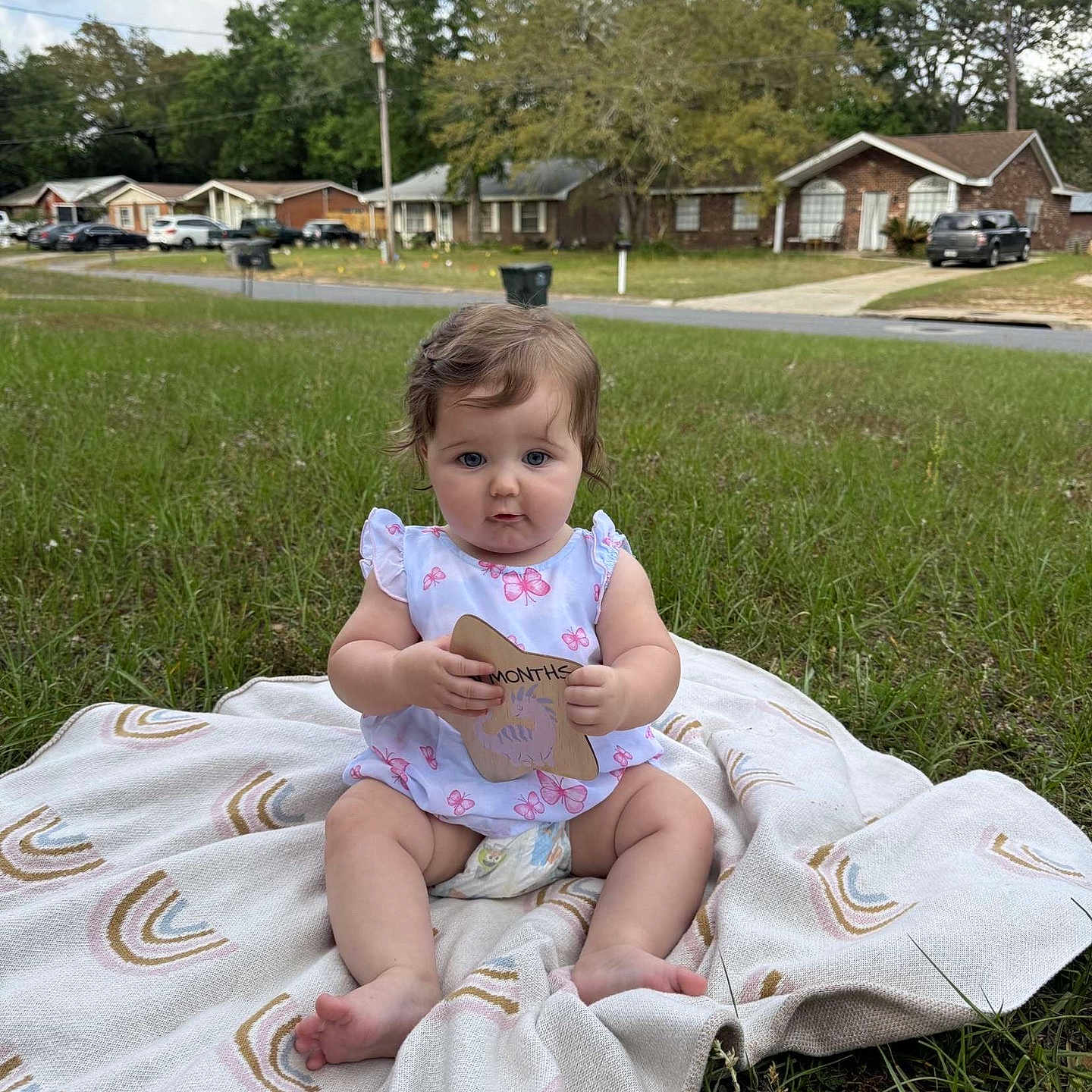 Riley joined the competition — help win amazing prizes! architecture, baby, backyard, building, face, grass, head, nature, neighborhood, outdoors, person, photography, plant, portrait, quilt, shelter, sitting, summer, tree, yard