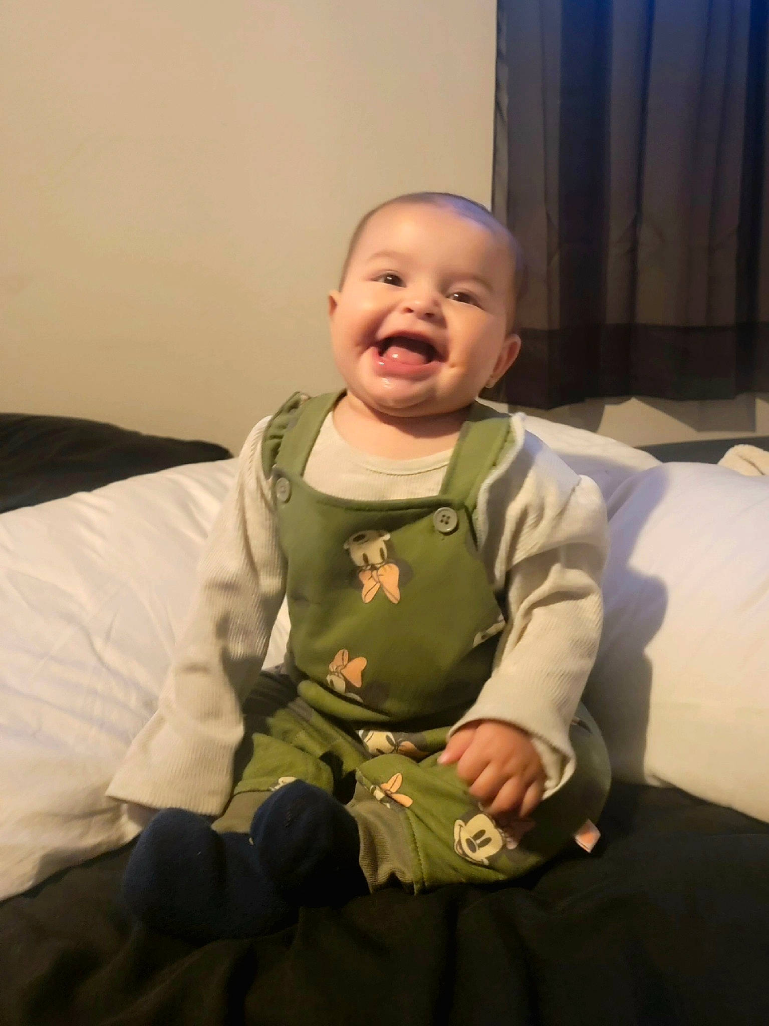 Zaylee is registered to the contest to win money with this photo: baby, baby_toddler_clothing, cheek, child, comfort, curtain, face, finger, fun, gesture, happy, human_body, nose, person, room, sitting, skin, sleeve, smile, thumb