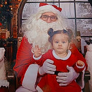 Kalissa participe au concours pour gagner de l'argent avec cette photo : chair, child, christmas, decorations, festive, gift_boxes, glasses, gloves, holiday, indoor, penguin_figure, person, plush_polar_bear, portrait, red_dress, santa_claus, snow, white_beard, window, winter