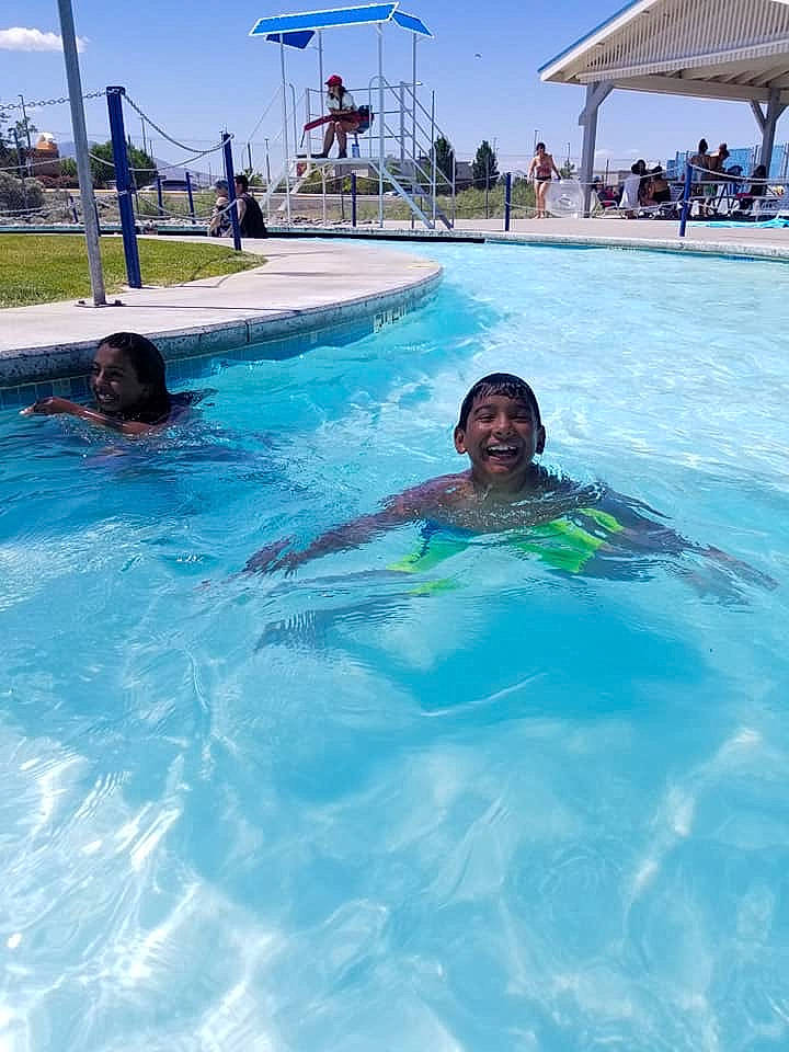 Junior is registered to the contest to win money with this photo: amusement_park, fun, joy, leisure, leisure_centre, nonbuilding_structure, park, person, recreation, resort, summer, swimming, swimming_pool, under_exposed, vacation, water, water_park