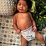 Anthony is registered to the contest to win money with this photo: baby, smiling, diaper, pillow, blanket, mickey_mouse, minnie_mouse, avocado_pattern, infant, cute, lying_down, child, soft_toy, patterned_bedding, socks, happy, indoor, face, skin, hair