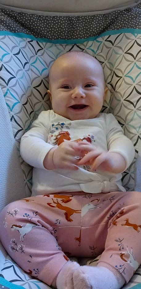 Jaelynn joined the competition — help win amazing prizes! baby, baby_products, baby_safety, baby_toddler_clothing, cheek, child, comfort, face, facial_expression, finger, happy, iris, linens, person, pink, product, skin, sleeve, smile, textile