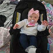 Aria joined the competition — help win amazing prizes! baby, infant, pacifier, headband, bow, car_seat, clothing, nike, sweatshirt, leggings, sock, blanket, fabric, pattern, indoor, cute, child, person, seated, casual
