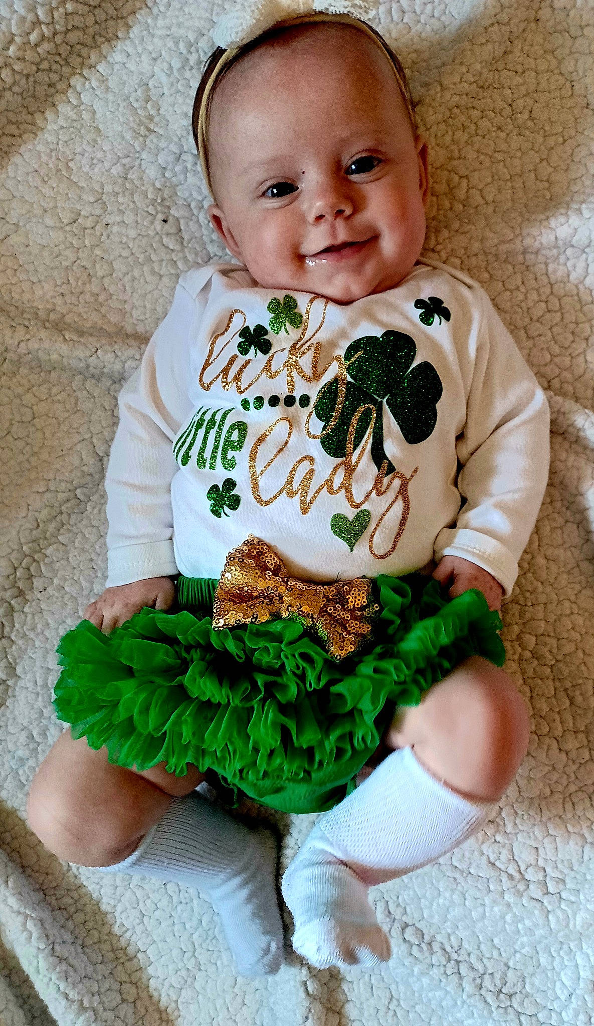 Ember is registered to the contest to win money with this photo: baby, baby_toddler_clothing, cheek, child, eye, face, green, hairstyle, happy, head, iris, neck, outerwear, pattern, person, skin, sleeve, smile, t_shirt, textile