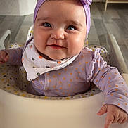 Alyäh participe au concours pour gagner de l'argent avec cette photo : baby, bib, blue_eyes, bow, cheeks, child, clothing, cute, face, flooring, hand, happy, headband, high_chair, indoor, infant, person, polka_dot, sitting, smile