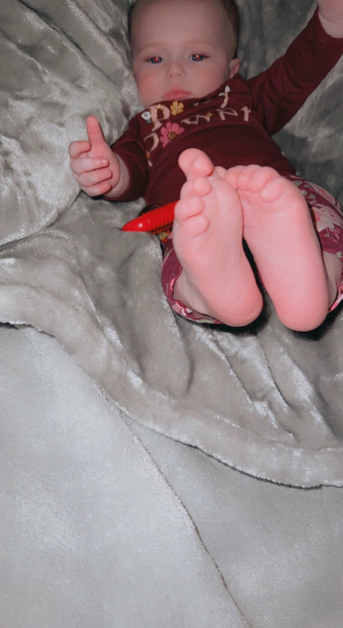 Julianne is registered to the contest to win money with this photo: arm, baby, baby_toddler_clothing, comfort, eye, finger, foot, gesture, hand, human_leg, leg, linens, nail, person, pink, sleeve, sock, textile, thigh, thumb