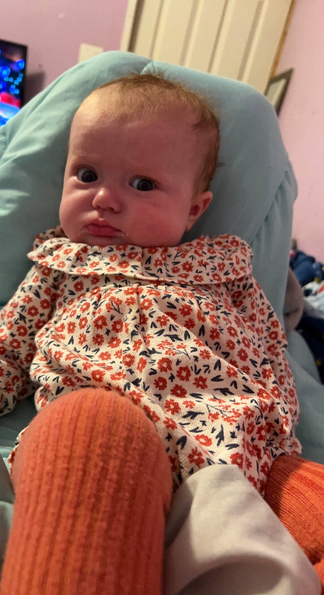 Julianne is registered to the contest to win money with this photo: baby, baby_products, baby_toddler_clothing, cheek, child, comfort, eye, finger, hairstyle, head, human_body, iris, linens, mouth, nose, person, product, sitting, skin, textile