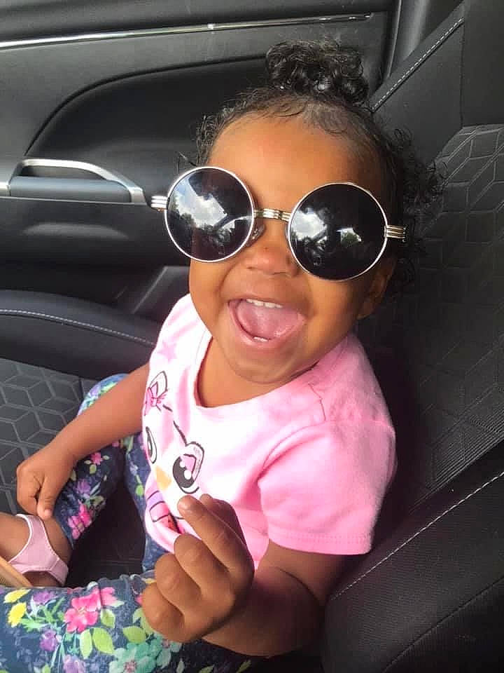 Daniyah is registered to the contest to win money with this photo: black_hair, car, car_seat, child, cool, eyewear, fun, glasses, goggles, person, pink, smile, sunglasses, toddler, vision_care