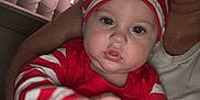 Ethyan joined the competition — help win amazing prizes! baby, child, person, red_clothing, striped_hat, striped_sleeves, indoor, window_blinds, arm, holding, face, blue_eyes, cheeks, casual, portrait, motion_blur, infant, candid, human, clothing