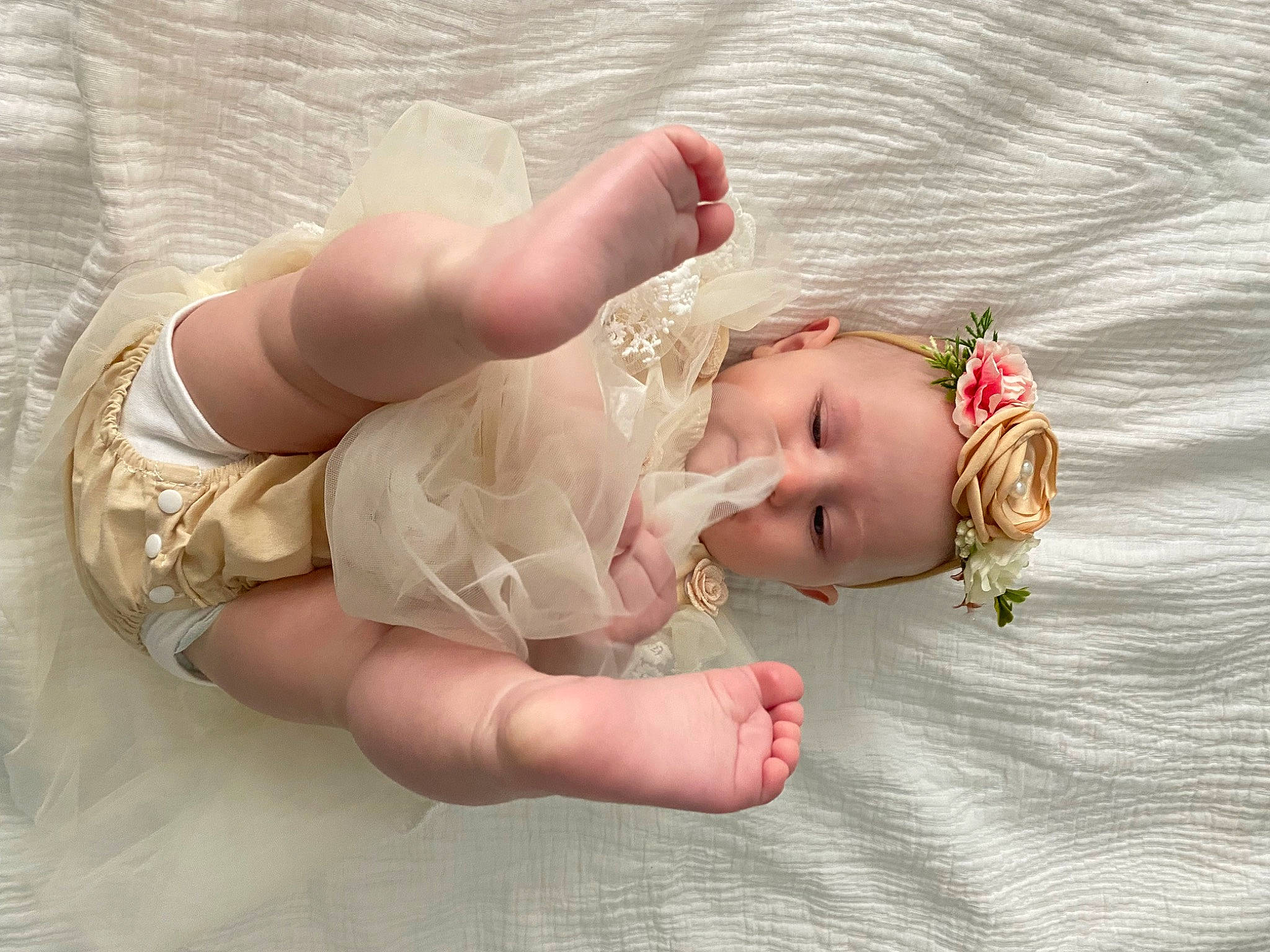 Locklynn is registered to the contest to win money with this photo: baby, baby_toddler_clothing, child, embellishment, fashion_accessory, finger, foot, gesture, grass, hair_accessory, hand, human_leg, nail, peach, person, pink, product, skin, thumb, toddler
