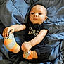 Teddy joined the competition — help win amazing prizes! baby, bed, black_clothing, blanket, blue, casual, child, cute, expression, face, feet, gray, hands, indoors, infant, lying_down, orange, person, socks, young