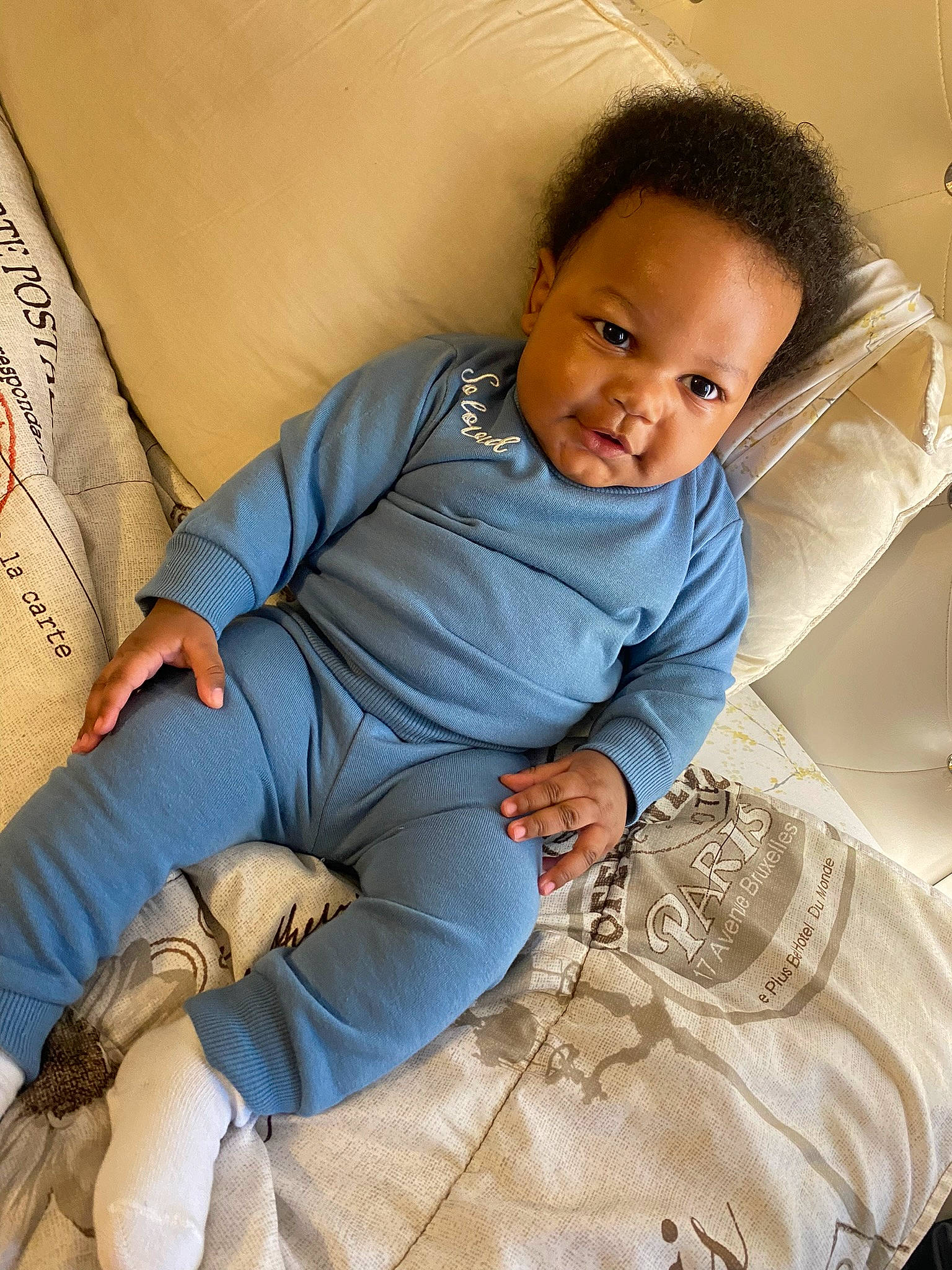 Moziah joined the competition — help win amazing prizes! baby, baby_toddler_clothing, child, comfort, elbow, electric_blue, flash_photography, flooring, hairstyle, happy, human_leg, knee, leg, linens, person, sitting, skin, sleeve, smile, thigh