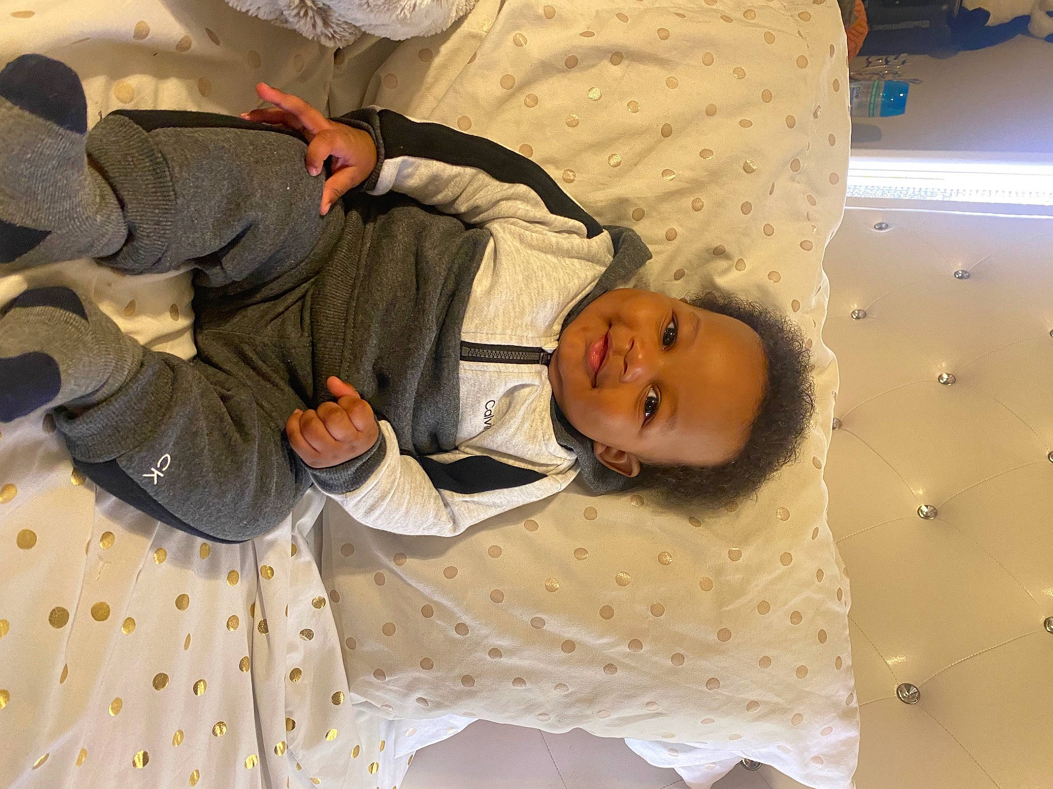 Moziah is registered to the contest to win money with this photo: baby, baby_products, baby_toddler_clothing, bedding, bedtime, ceiling, child, comfort, flooring, fun, happy, joy, linens, nap, pattern, person, room, sleep, textile, toddler