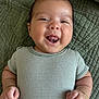 baby, smiling, tongue_out, striped_clothing, bracelet, green_blanket, infant, cute, happy, closeup, portrait, child, skin, hand, face, lying_down, soft_light, young, one_piece, adorable