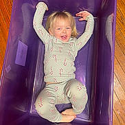 Everly joined the competition — help win amazing prizes! barefoot, candy_cane_pattern, casual, child, clothing, cute, fun, happy, indoor, joyful, pajamas, person, plastic_bin, playful, purple_bin, relaxed, smiling, toddler, wooden_floor, young_child