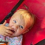 Everly is registered to the contest to win money with this photo: toddler, child, blue_eyes, blonde_hair, snack, hand, red_seat, black_straps, floral_shirt, cute, curious, sitting, fabric, young_child, portrait, indoor, smiling, baby, person, snacking