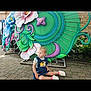 Everly joined the competition — help win amazing prizes! toddler, child, sitting, outdoor, colorful, floral, decoration, green, purple, cobblestone, footwear, short_sleeve, blonde_hair, daylight, side_view, curious, casual_clothing, nature, background, playful