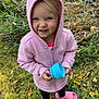 Everly is registered to the contest to win money with this photo: blue_cup, casual_clothing, child, cute, daylight, footwear, grass, greenery, happy, holding_object, nature, outdoor, person, pink_hoodie, pink_sandals, playful, portrait, smiling, toddler, young_child