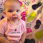 Paizley is registered to the contest to win money with this photo: baby, child, infant, pink_shirt, love_bug, fruit_pattern, blanket, strawberry, blackberry, lime, cute, portrait, sitting, indoor, face, hands, clothing, expression, young, person