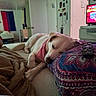 bandana, bed, bedding, bedroom, blanket, cozy, dog, dresser, flag, furniture, indoor, mirror, patterned_pillow, paw, pet, pillow, relaxed, remote_control, sleeping_dog, tv_screen