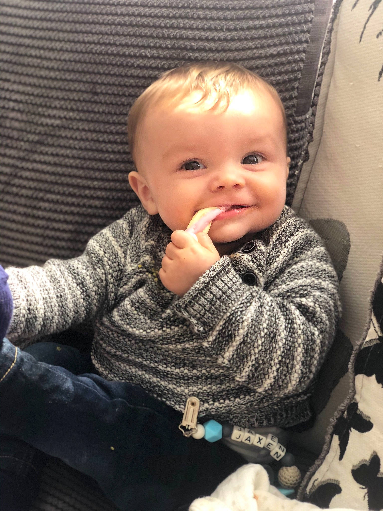 Jaxen is registered to the contest to win money with this photo: baby, cheek, child, chin, electronic_device, eye, face, finger, hand, head, iris, lip, mouth, nose, outerwear, people, person, sitting, skin, smile