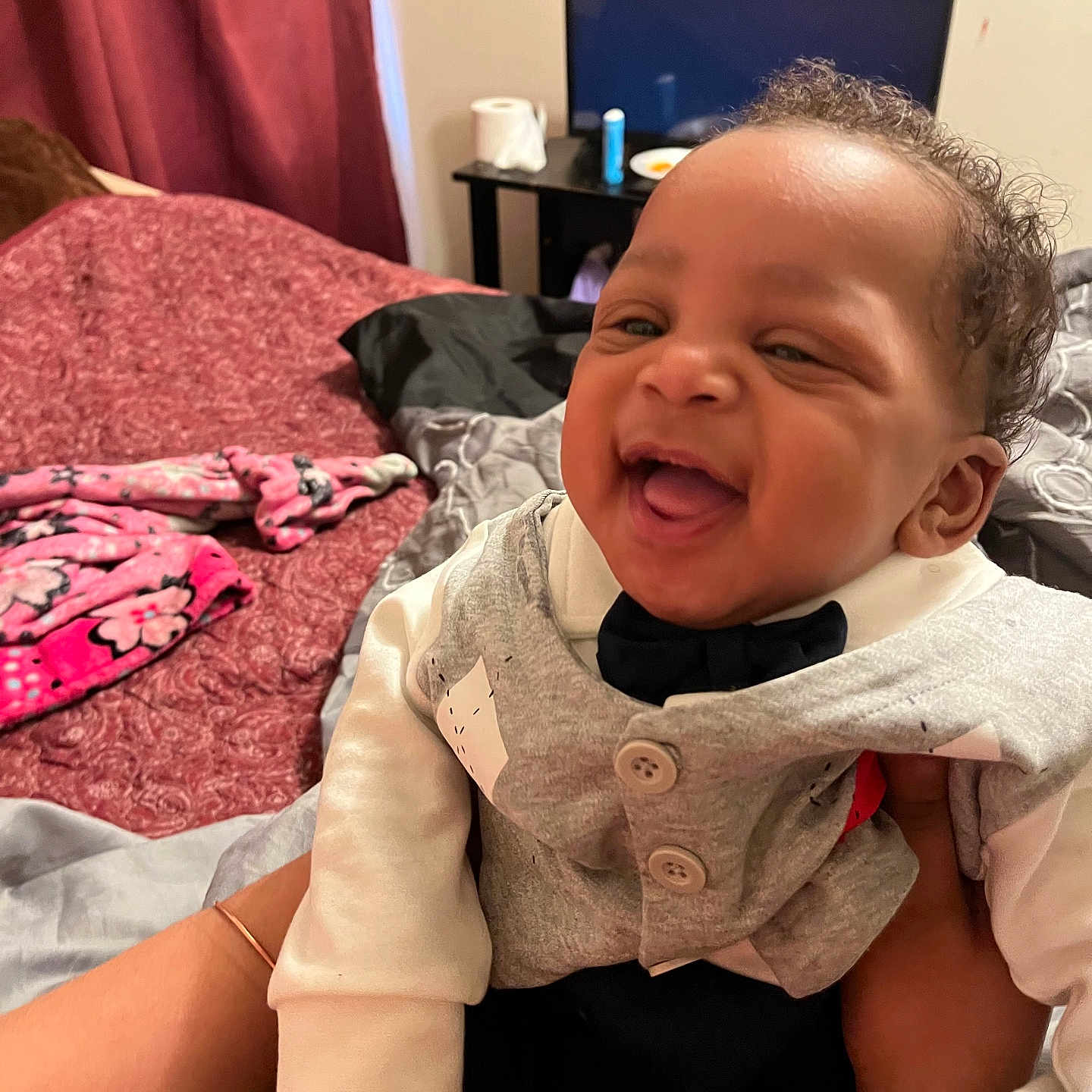 Sincere joined the competition — help win amazing prizes! baby, smiling, laughing, child, indoor, blanket, bed, curtain, television, furniture, clothing, person, happy, portrait, cute, infant, hand, bracelet, cozy, curly_hair