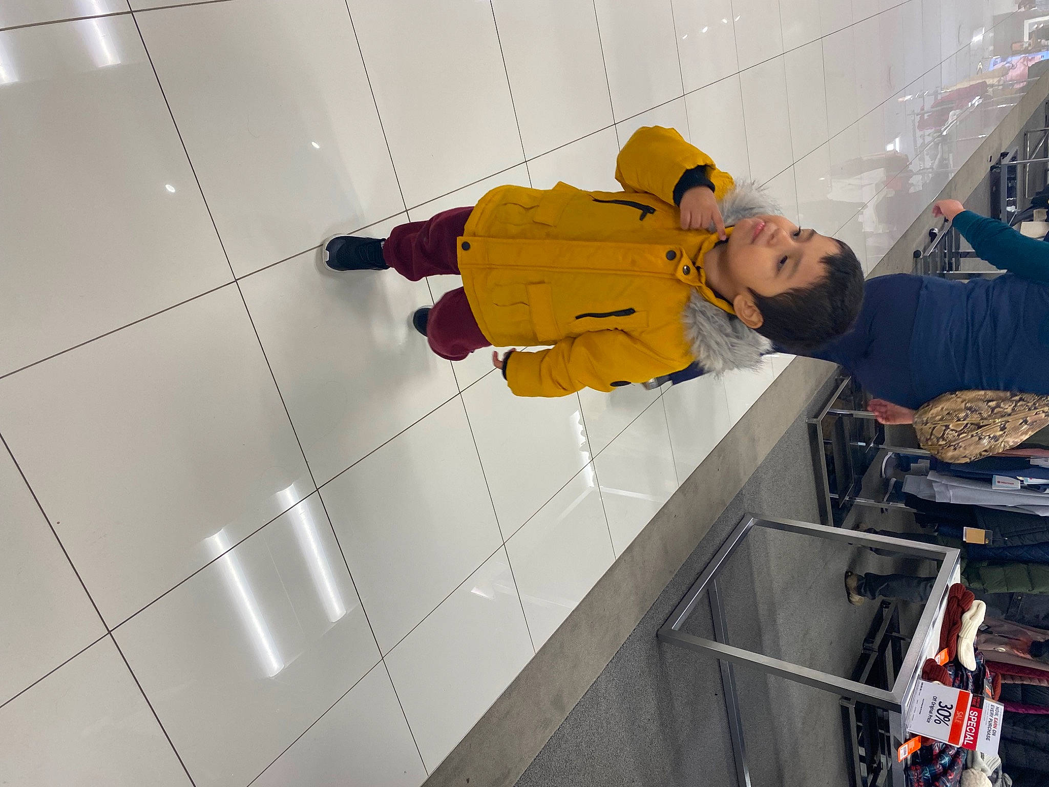 Jeremiah is registered to the contest to win money with this photo: adventure, ceiling, child, cleanliness, flooring, fun, hat, hoodie, jacket, leisure, person, recreation, room, smile, toddler, wall