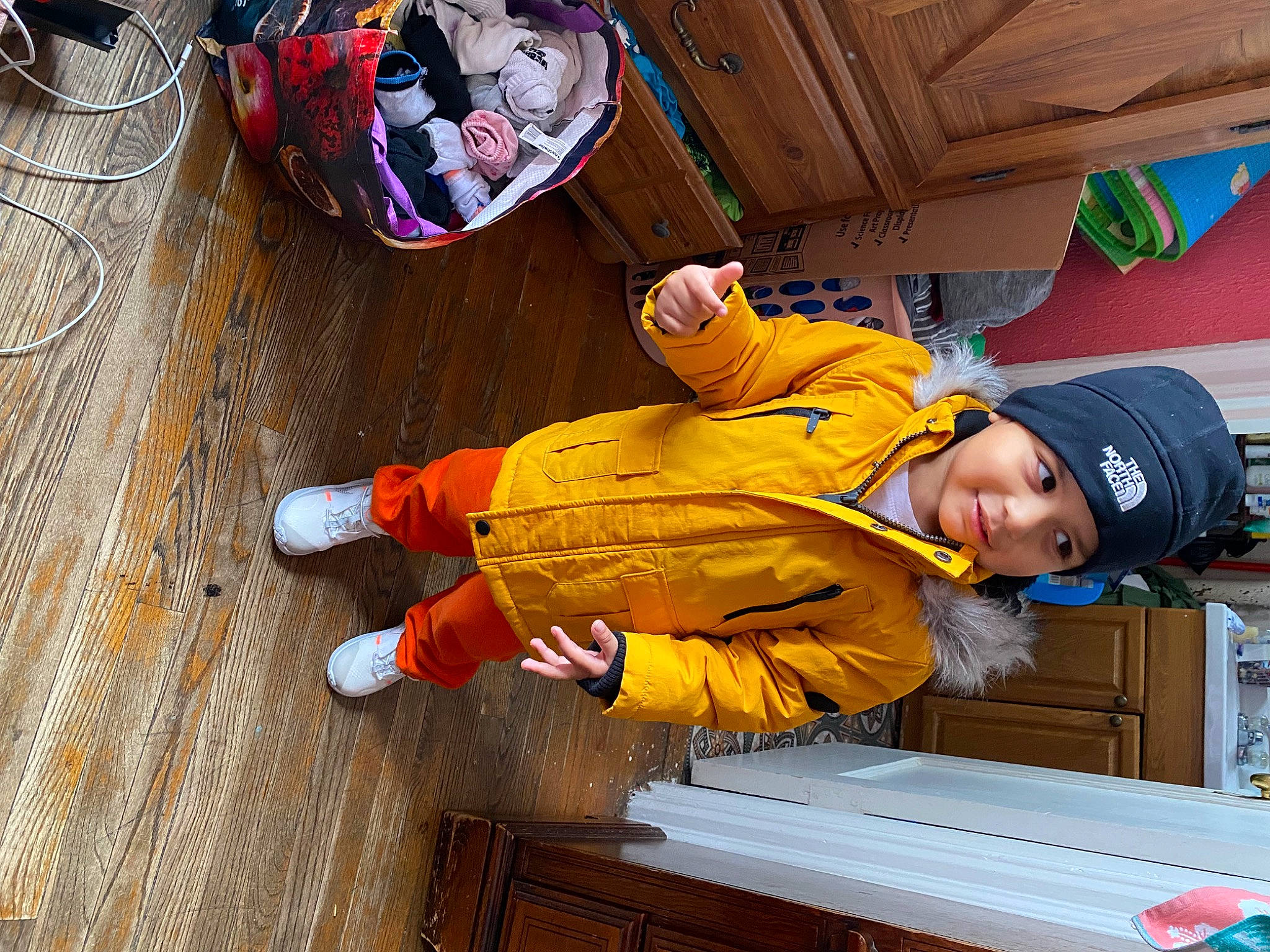 Jeremiah joined the competition — help win amazing prizes! baseball_cap, cap, child, flooring, fun, hardwood, hat, headwear, hoodie, leisure, orange, outdoor_shoe, person, personal_protective_equipment, smile, tableware, toddler, varnish, walking_shoe, wood