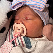 Kendra joined the competition — help win amazing prizes! baby, blanket, blue, bow, closeup, cozy, cute, face, hat, infant, newborn, pacifier, peaceful, pink, skin, sleeping, soft, striped, striped_clothing, white